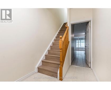A staircase with wooden steps and a white wall.