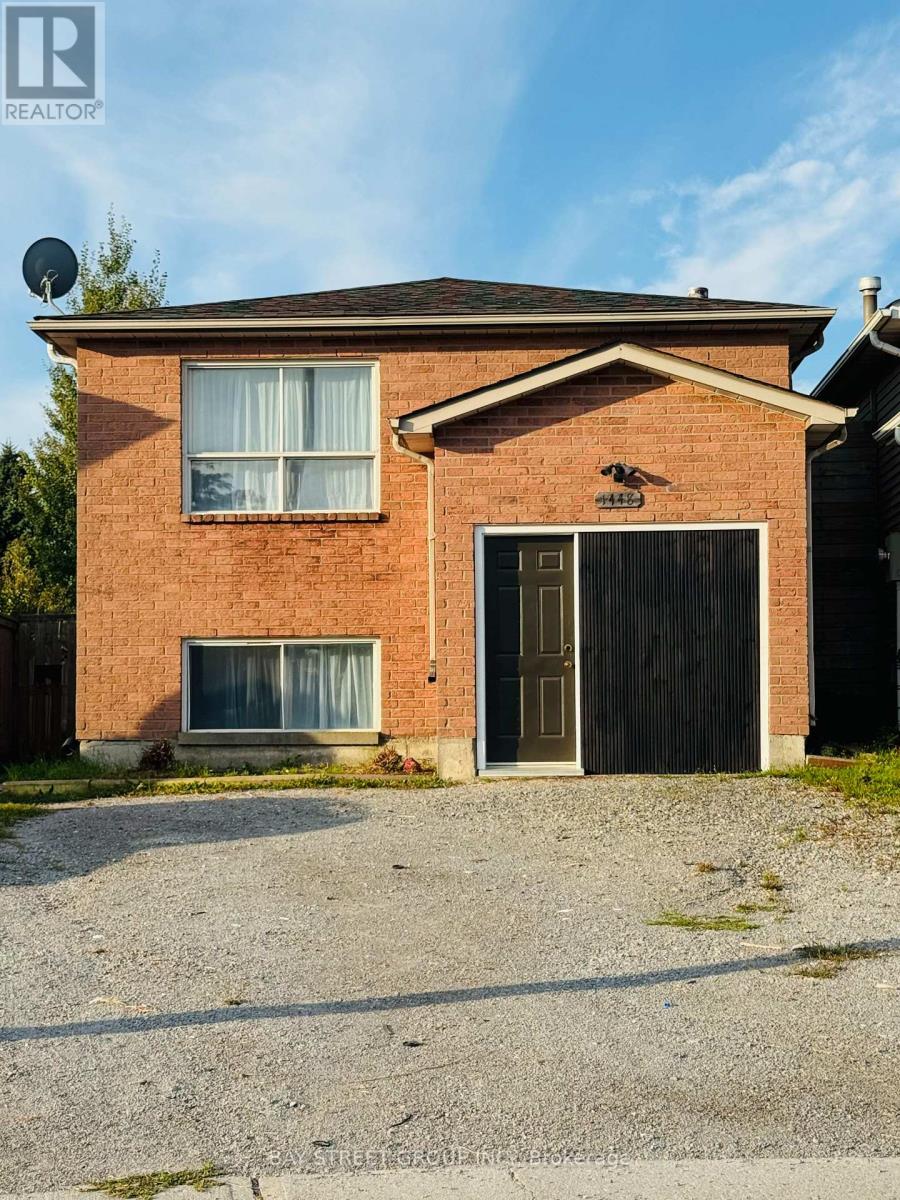 A house with a garage and a satellite dish on the roof.