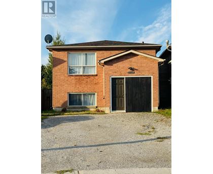 A house with a garage and a satellite dish on the roof.