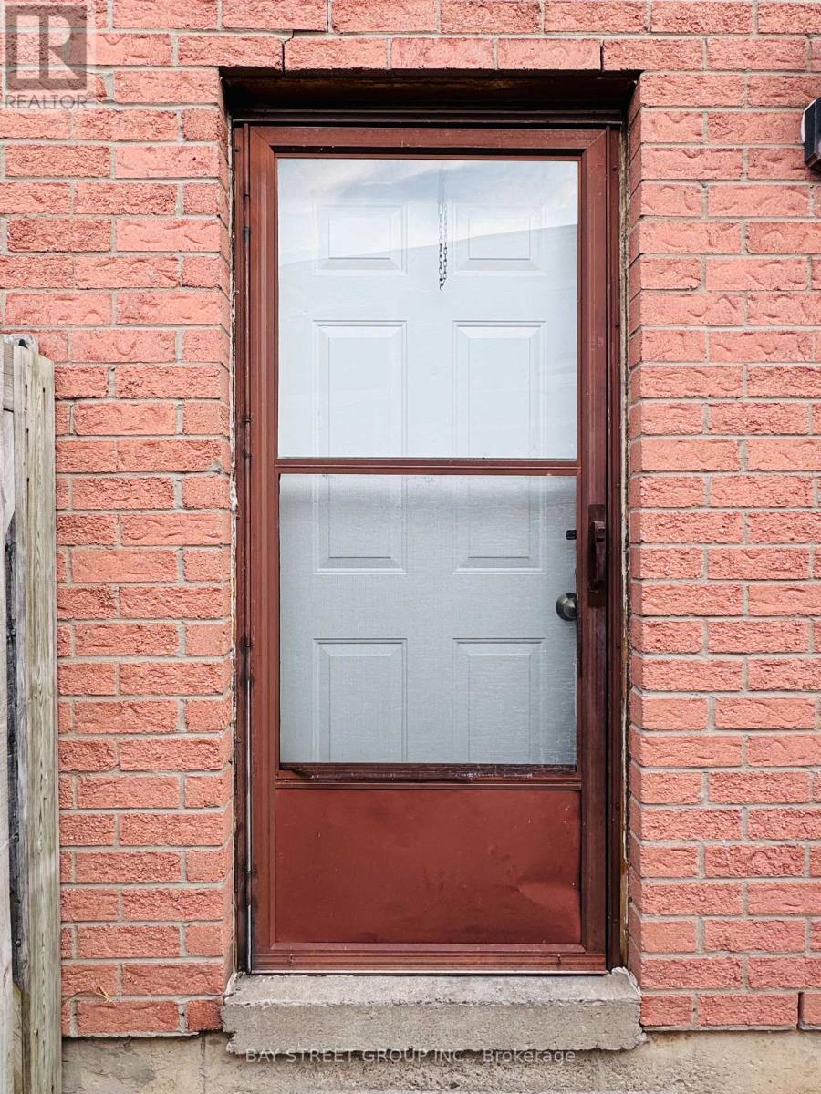 A red door with a glass window and a handle.