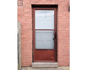 A red door with a glass window and a handle.