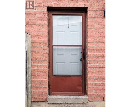 A red door with a glass window and a handle.