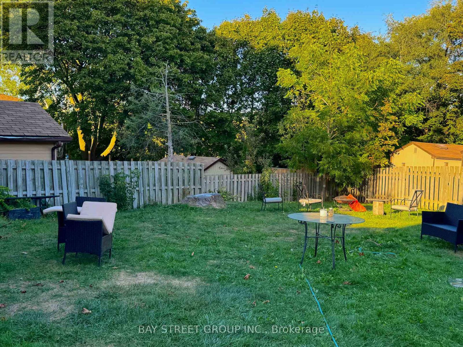 A backyard with a table and chairs.