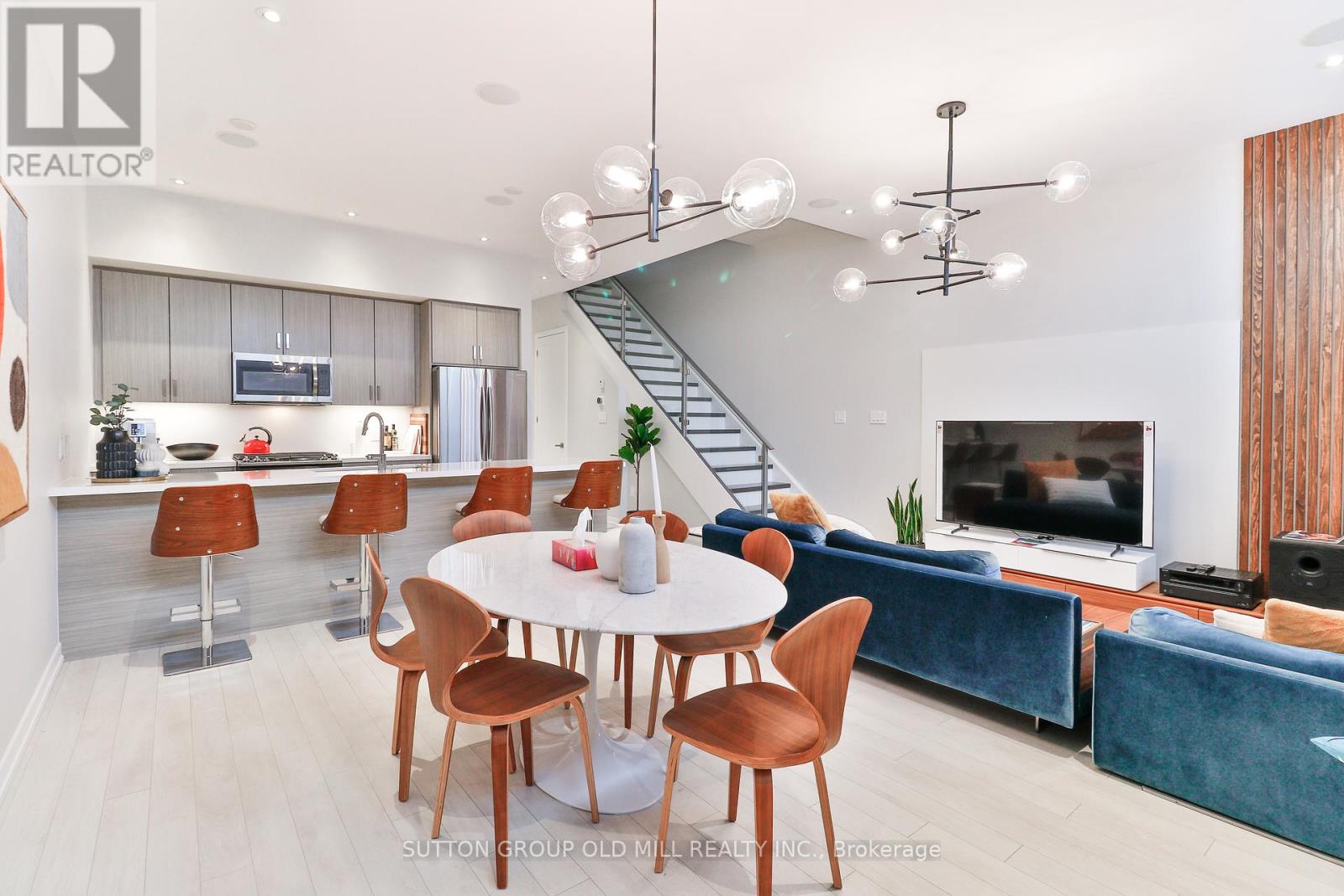 A modern dining room with a round table and chairs.
