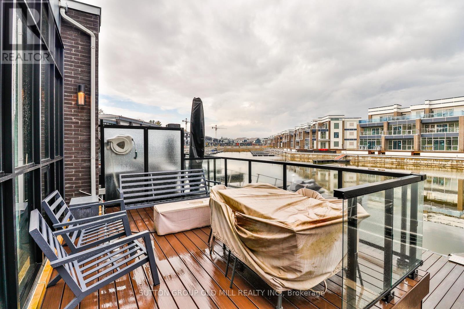 A balcony with a table and chairs and a hot tub.
