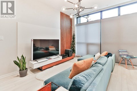 A living room with a blue couch and a television.