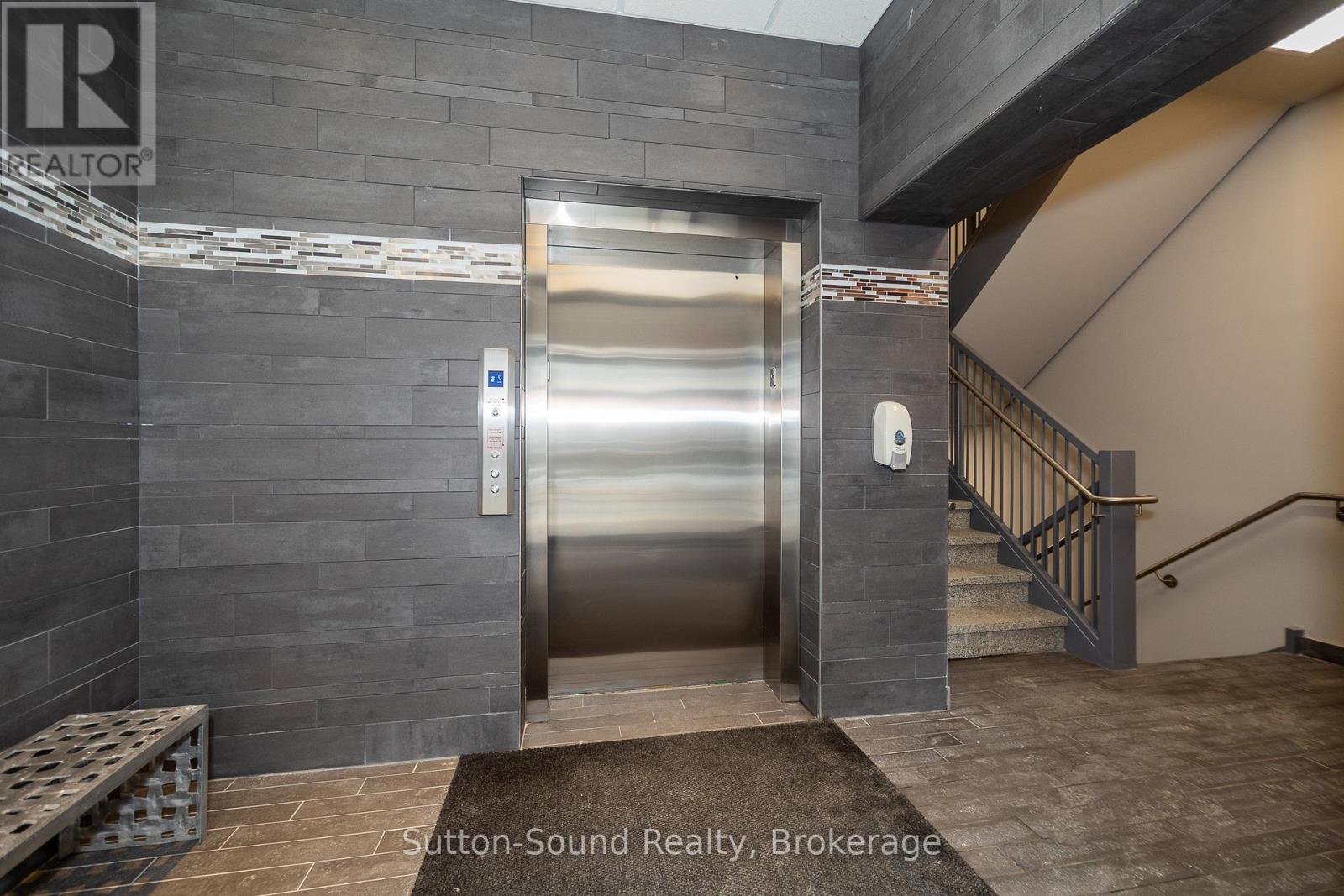 A stainless steel elevator with a button panel and a wall mounted control panel.