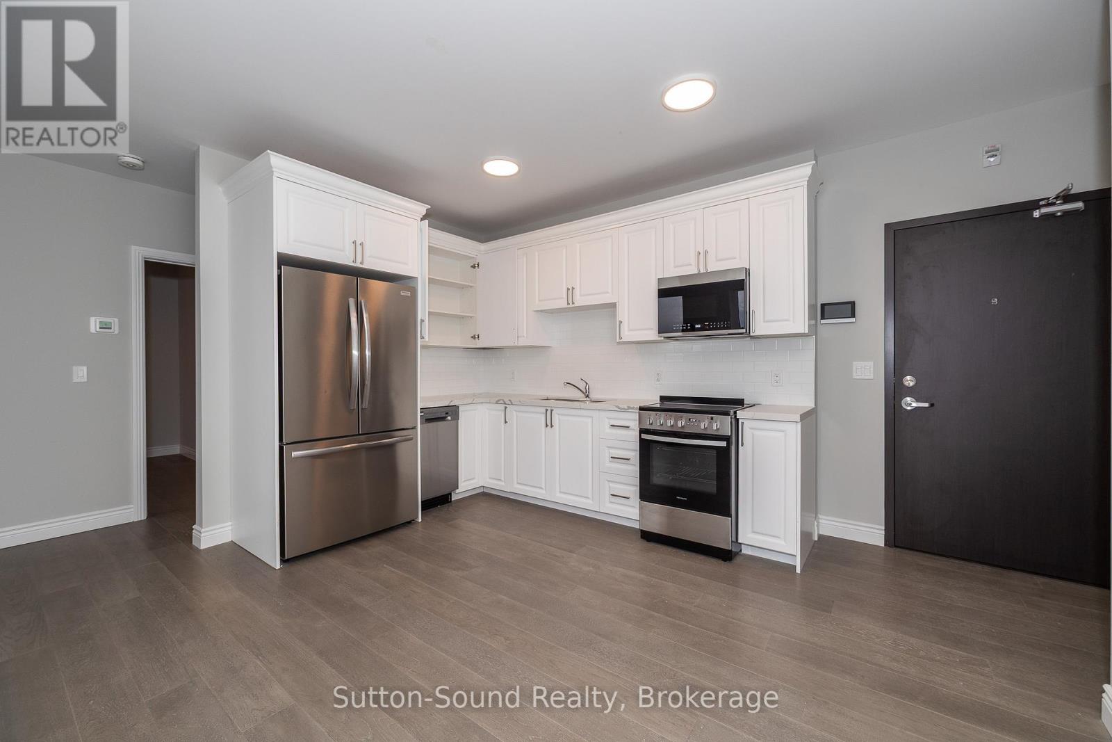 A kitchen with white cabinets and stainless steel appliances.