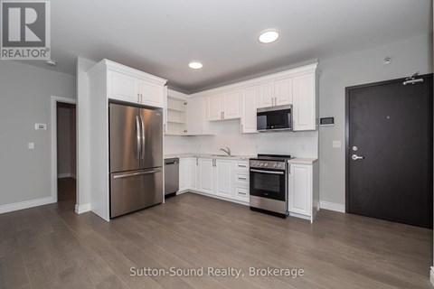A kitchen with white cabinets and stainless steel appliances.