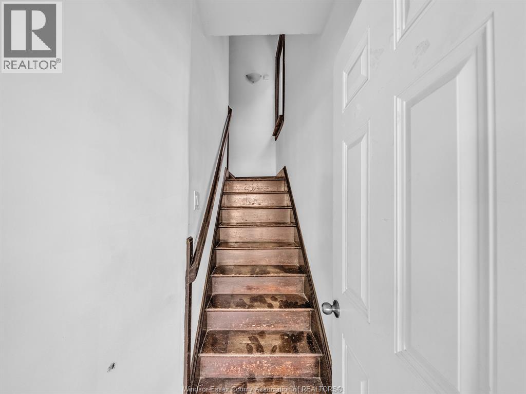A staircase with a white door on the side.