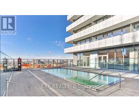 A pool on a balcony of a building with the words EXP REALTY Brokerage on the bottom.