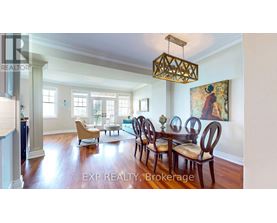 A dining room with a wooden table and chairs.