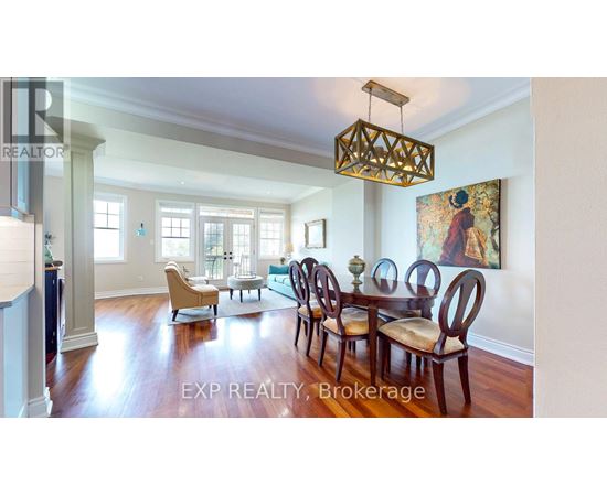 A dining room with a wooden table and chairs.