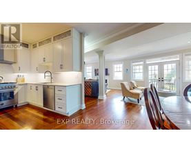A kitchen with white cabinets and a wooden floor.