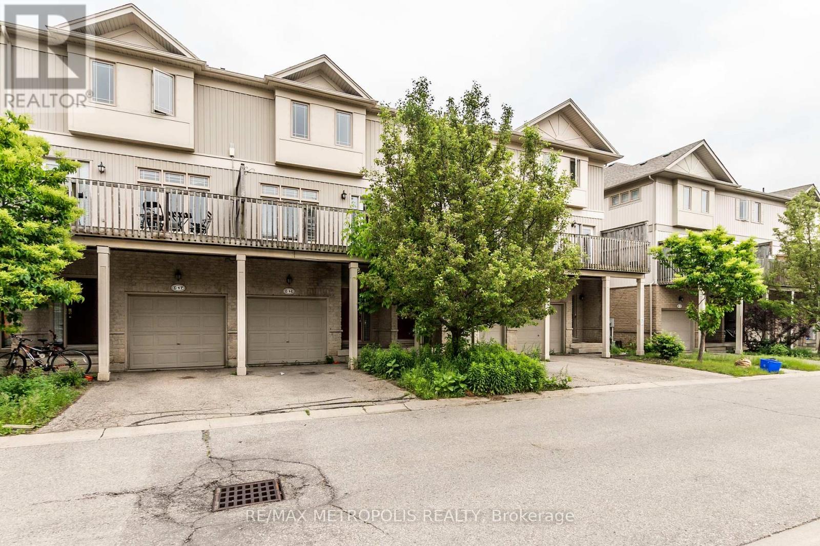 Apartment complex with a pothole in the driveway.