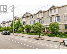 A street view of a residential area with apartment buildings and parked cars.