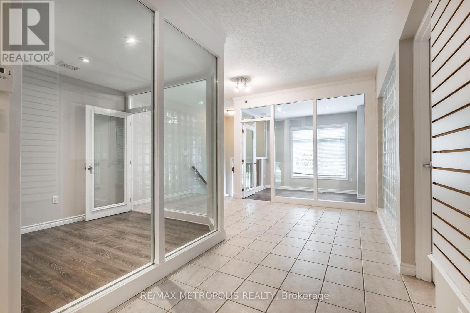 A spacious room with a glass door leading to a balcony.