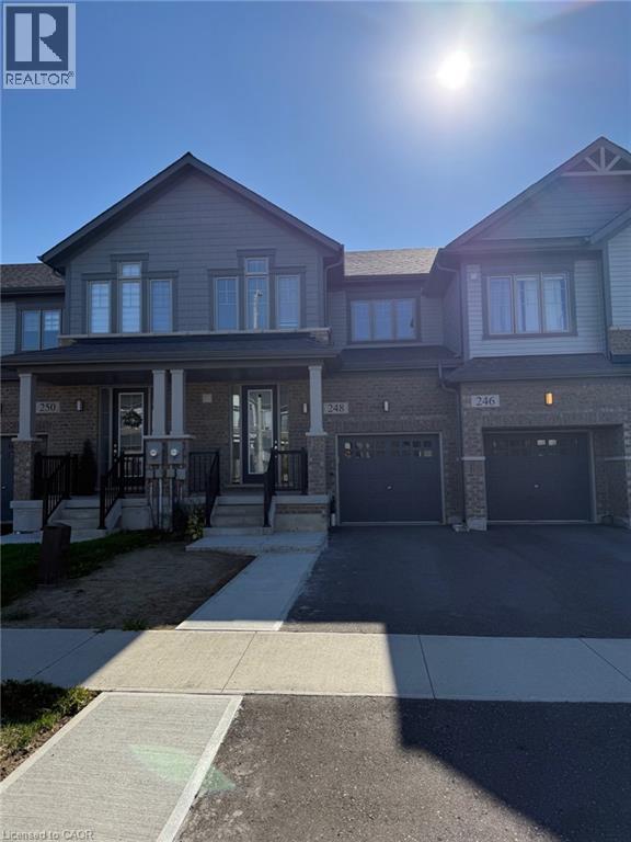 A sunny day at a realtor's property with a house and garages.