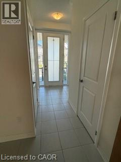 A hallway with a door at the end.