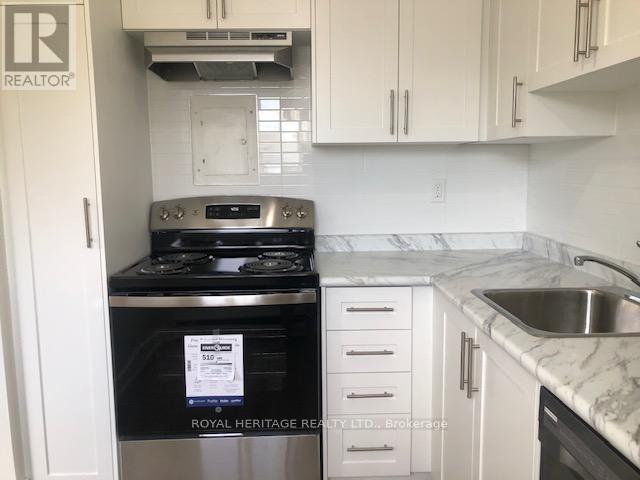 A kitchen with a stove top oven and a sink.