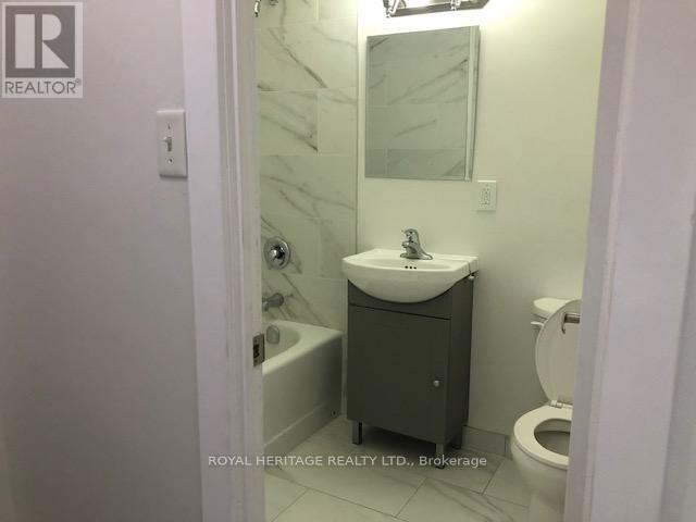 A bathroom with a sink, toilet and bathtub.
