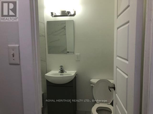A white sink and toilet in a small bathroom.