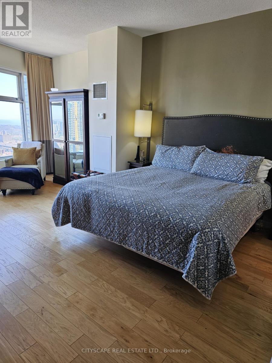 A bedroom with a large bed and a view of the city.