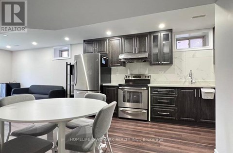 A modern kitchen with a table and chairs.