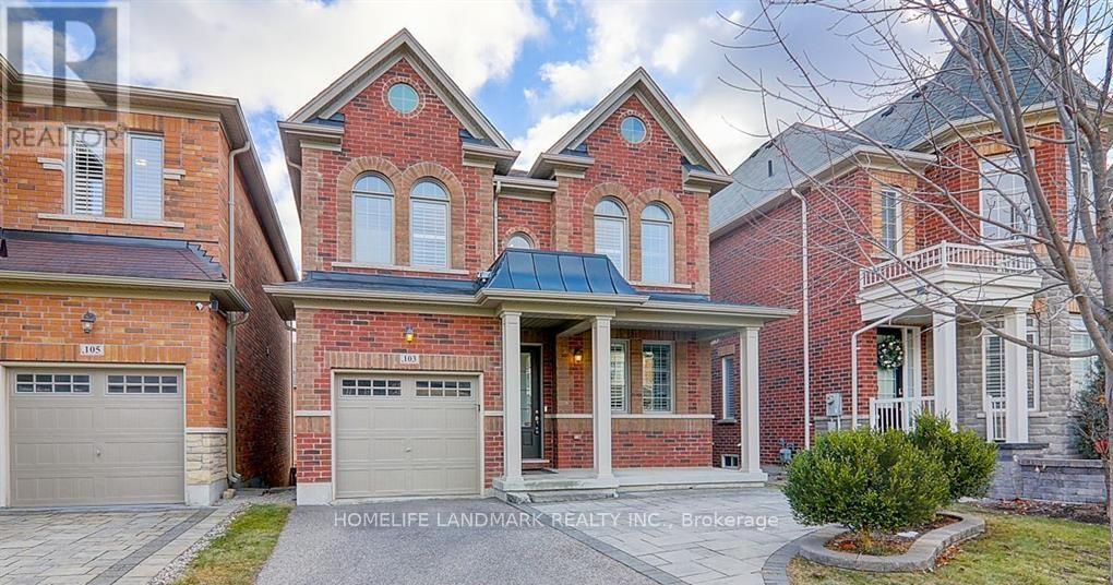 A brick house with a garage is for sale.