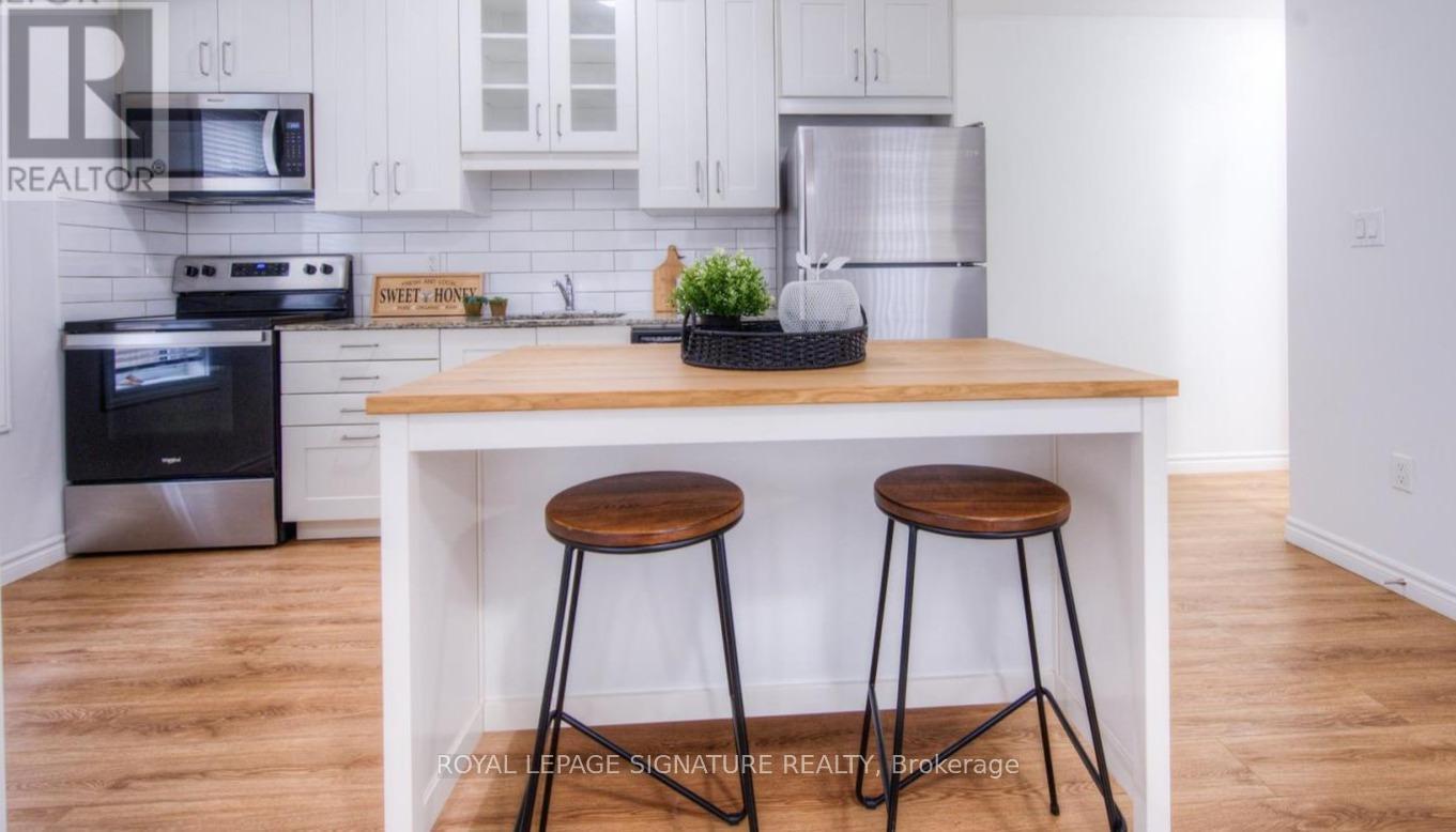 A kitchen with a white cabinet and a black stove top oven.