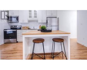 A kitchen with a white cabinet and a black stove top oven.