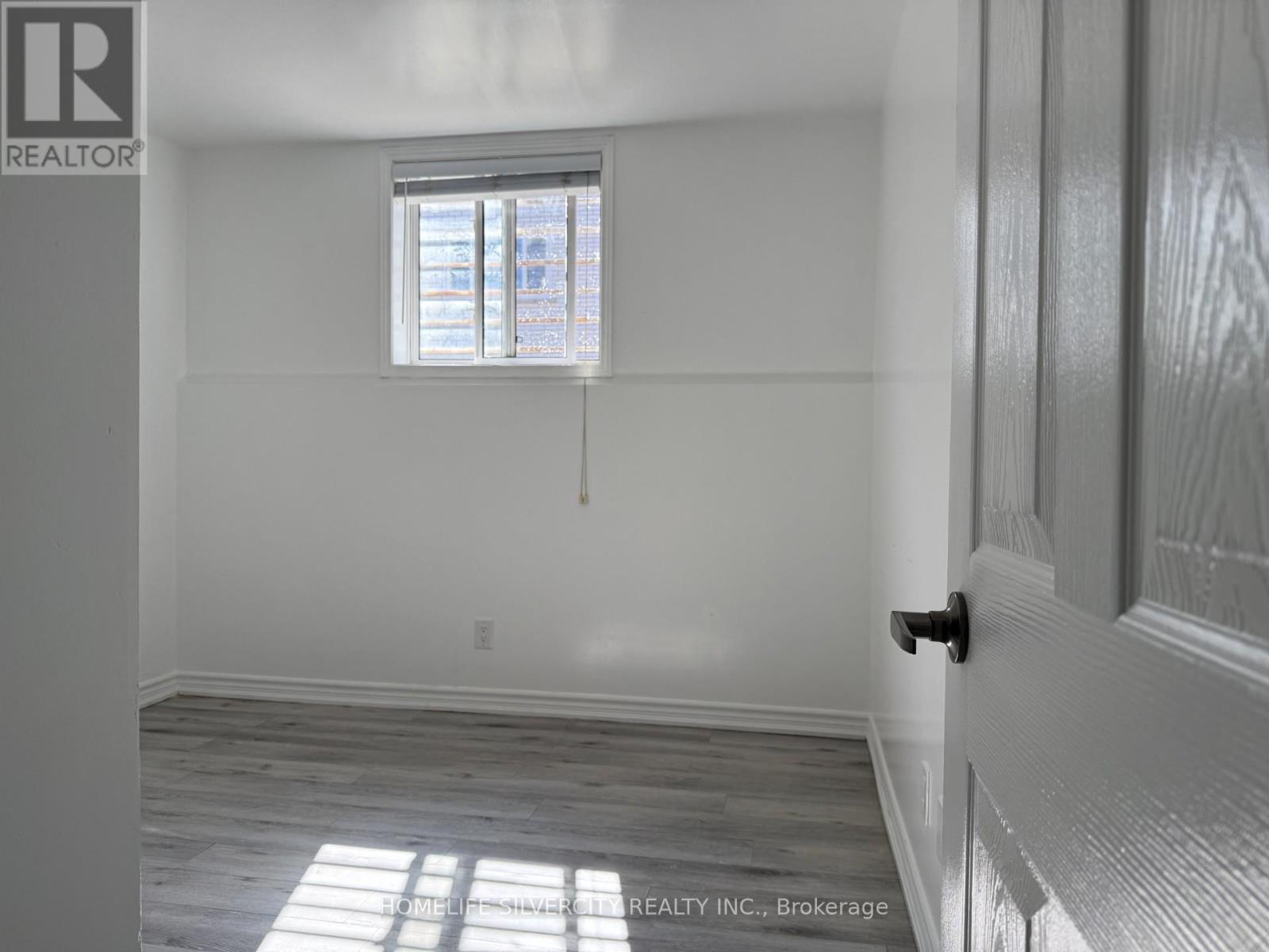 A room with a window and a door.