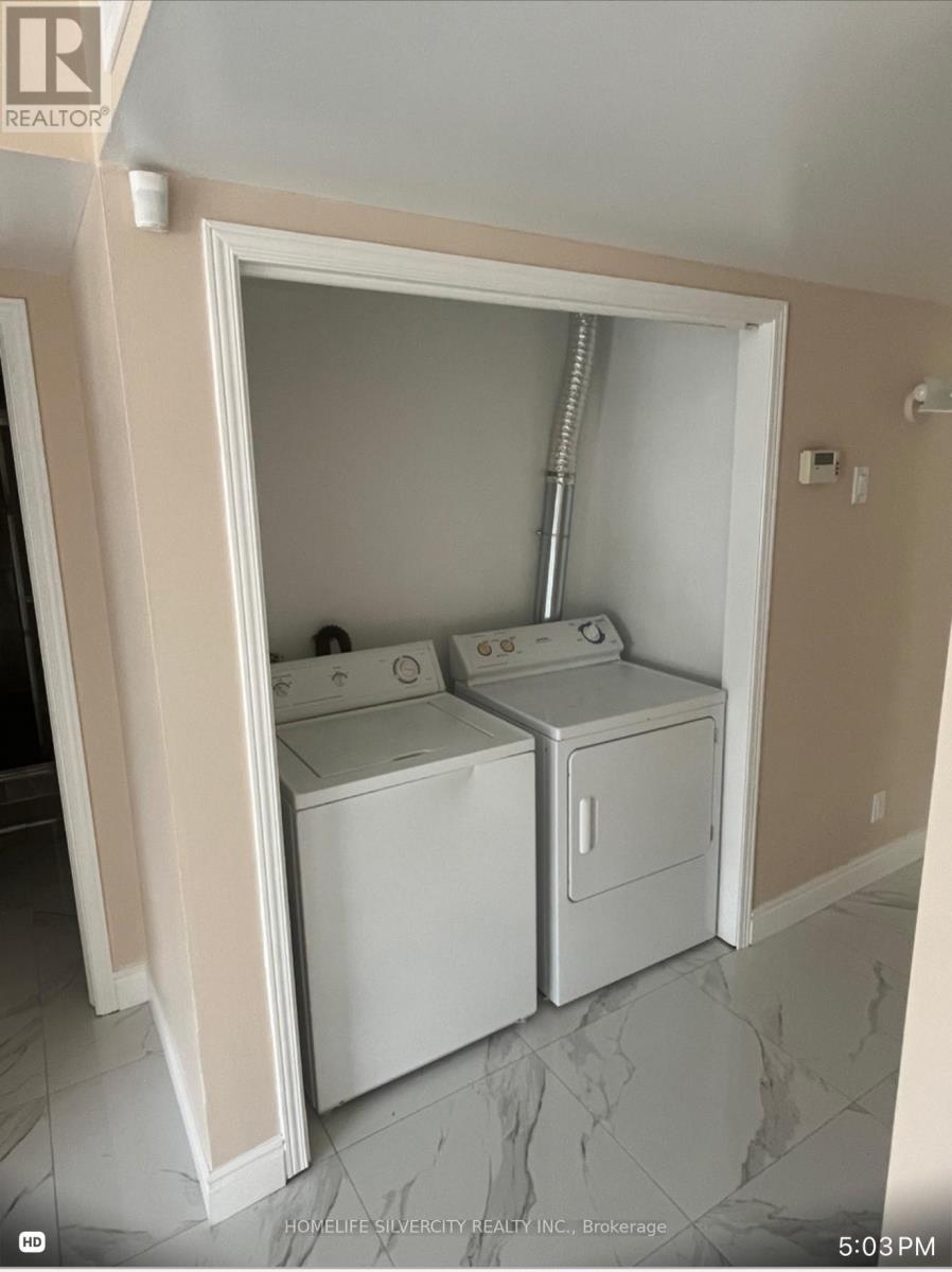 A small laundry room with a washer and dryer.