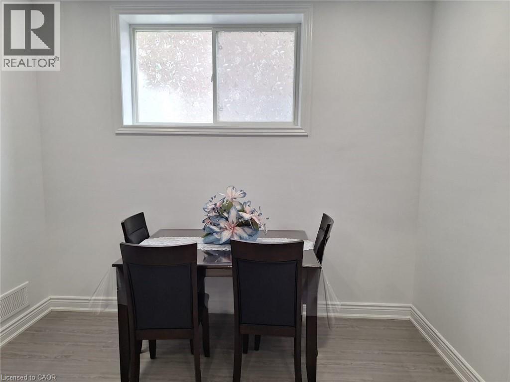 A dining room with a table and chairs.