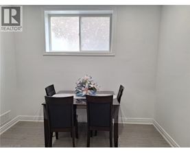 A dining room with a table and chairs.