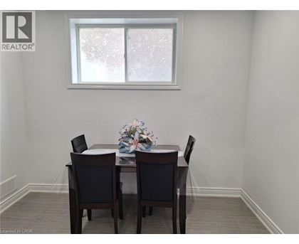 A dining room with a table and chairs.