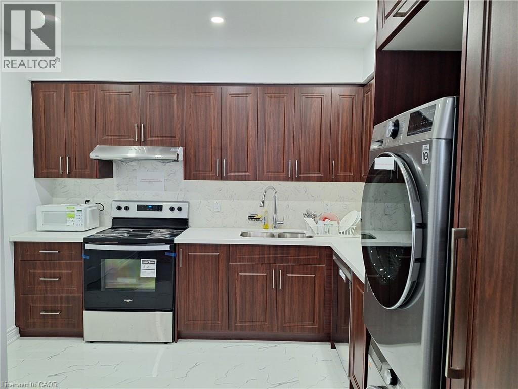 A modern kitchen with wooden cabinets and stainless steel appliances.