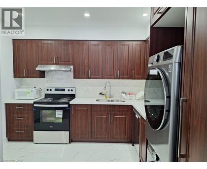 A modern kitchen with wooden cabinets and stainless steel appliances.