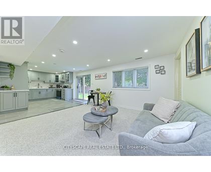 A living room with a grey couch and a coffee table.