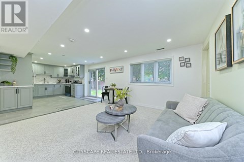 A living room with a grey couch and a coffee table.