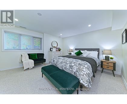 A bedroom with a large bed and a green bench.