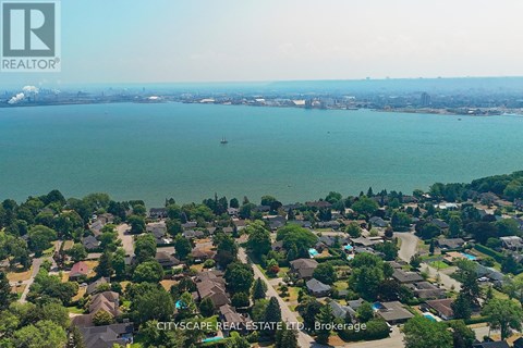 A bird's eye view of a residential area with houses and trees.
