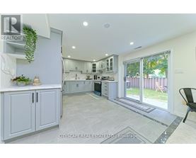 A real estate listing image of a kitchen and dining area.