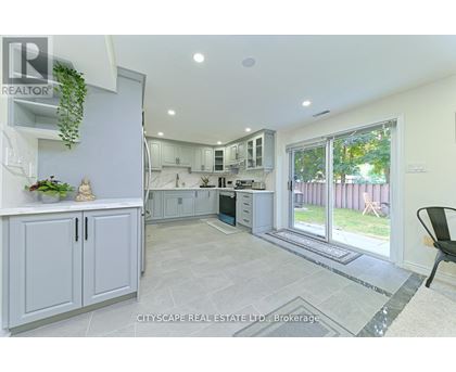 A real estate listing image of a kitchen and dining area.