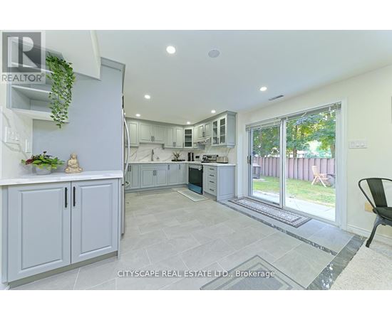A real estate listing image of a kitchen and dining area.