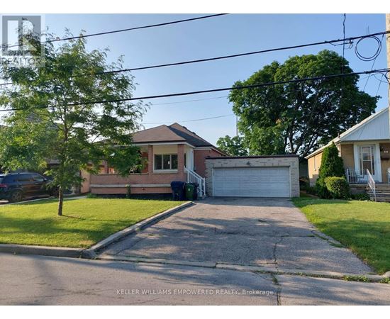 A residential street with houses and a car parked on the side.