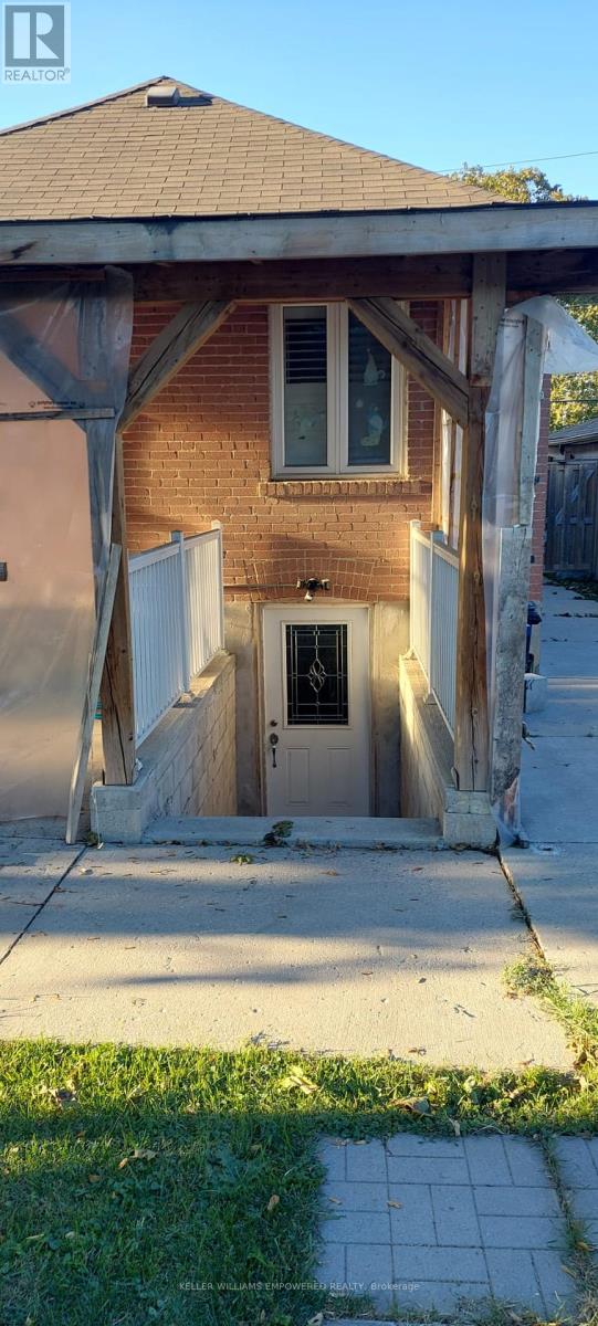 A house with a brown brick exterior and a white door.