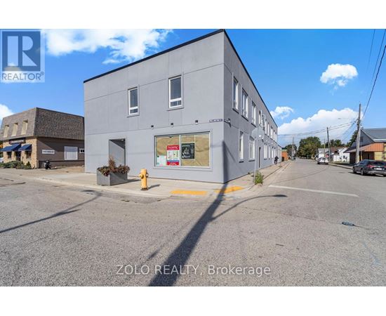 A grey building with a sign that says ZOLO REALTY Brokerage.