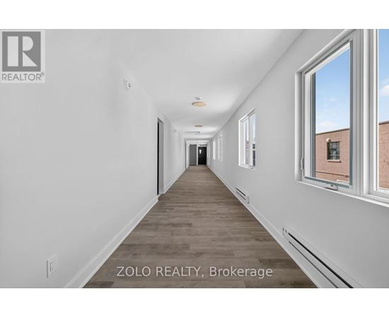 A long, empty hallway with a window on the right side.