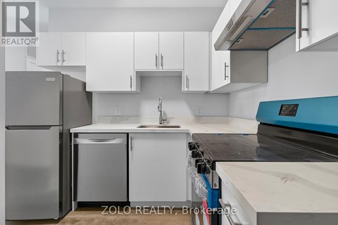 A kitchen with white cabinets and a blue counter.
